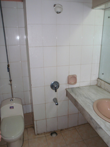 Shower in middle of bathroom with no shower stall.
